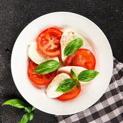 Caprese salad mozzarella and tomato, basil fresh delicious gourmet food background on the table rustic food top view copy space keto and paleo diet vegan and vegan food