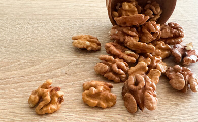 Peeled walnuts. On a wooden board. Healthy food. Natural background.