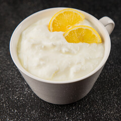 Lemon yogurt natural product skyr sour milk skir fresh delicious gourmet food background on the table rustic food top view copy space keto and paleo diet vegetarian food