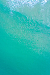 Tropical water texture with gentle white foam travel destination concept