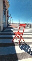 Fototapeta premium Red chair sidewalk cafe seaside sunny day crosswalk