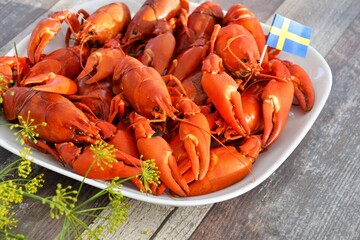 On the plate are crayfish boiled in beer with dill. Crayfish parties in Sweden.