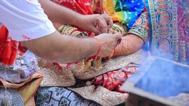 Authentic scene of a traditional Indian marriage vidhi, capturing sacred rituals performed around the holy fire (Agni) under a decorated mandap.