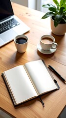 Open notebook, coffee, laptop on a wooden desk