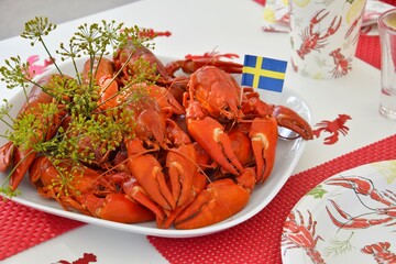 On the plate are crayfish boiled in beer with dill. Crayfish parties in Sweden.