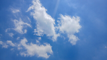 Bright Blue Sky with Fluffy White Clouds on a Sunny Day