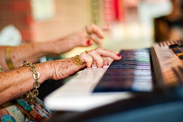 Hands touching a musical keyboard.