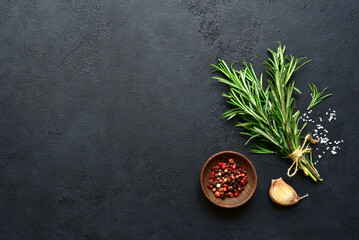 Cooking background with spices : bunch of rosemary , garlic and sea salt. Top view with copy space.