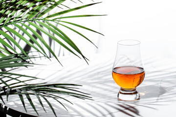 Experience the rich flavors of single malt scotch whisky in a glencairn glass surrounded by vibrant...