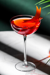 Red italian spritz alcoholic cocktail drink with gentian bitters, juice, sparkling wine and orange twist