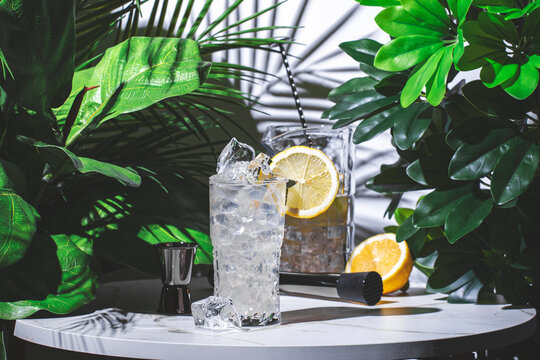 non-alcoholic cocktail drink or mocktail with syrup, juice, tonic water and a lemon wheel