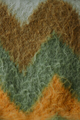 Close-up of traditional handmade Hutsul woolen rug with colorful woven texture. Natural fibers and folk patterns reflect Ukrainian cultural heritage and artisanal craftsmanship.