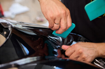 Applying a Protective Film on the Surface of Your Car for Enhanced Durability and Shine