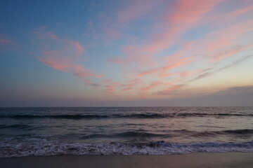 Ocean at Sunset hour with pink clouds