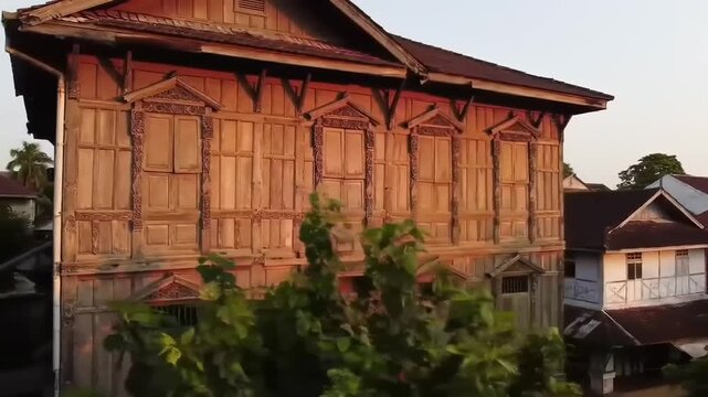 Large, ornate wooden house at dawn or dusk
