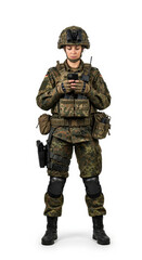 Fototapeta premium Female soldier in camouflage uniform standing and using smartphone, equipped with tactical gear, helmet, and communication device, isolated on white background