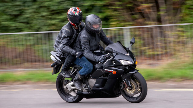 Milton Keynes,Bucks,UK - Aug 3rd 2025:  Man and pillion passenger on a 2006 Honda CBR 1000 rr  motorcycle travelling on a British road