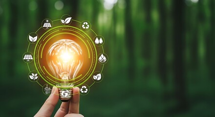 Eco-friendly concept with a hand holding a glowing light bulb encircled by green renewable energy and environmental icons in nature.