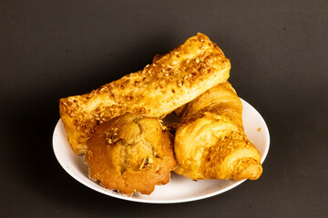Flaky Croissant with Fresh Berries and Banana on Vibrant Yellow
