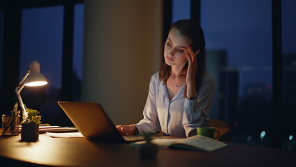 Tired freelancer looking monitor laptop at dark office closeup. Fatigued lady 