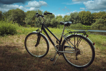 Fototapeta premium City bike on the grass by the river