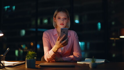 Manager reading sms dark office workspace closeup. Confident businesswoman