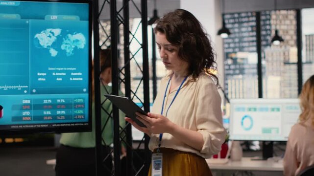 Empowered CEO examining monthly reports data for efficiency, guaranteeing multinational company success by reviewing indicators for strategic planning. Building strong vision. Camera B.