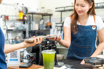 Small business entrepreneur barista coffee shop cafe restaurant. Customer using credit card on...