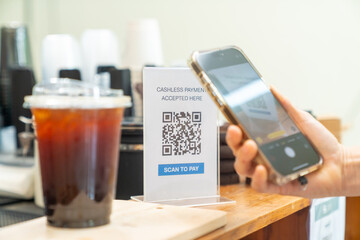 Small business entrepreneur coffee shop barista cafe restaurant. Customer buy beverage using credit card on smartphone app scan QR code at cashier counter making online banking payment at coffee shop.