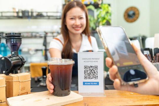 Small business entrepreneur coffee shop barista cafe restaurant. Customer buy beverage using credit card on smartphone app scan QR code at cashier counter making online banking payment at coffee shop. - Powered by Adobe