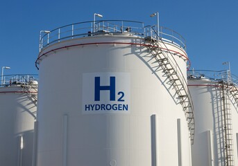 Hydrogen storage tanks for alternative energy with ladders and blue sky view