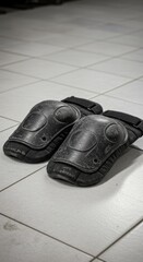 Black knee pads on tile floor