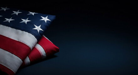 Dignified folded American flag resting on a dark blue background with ample copy space, symbolizing patriotism and national remembrance. Perfect for Memorial Day, Veterans Day, or other patriotic