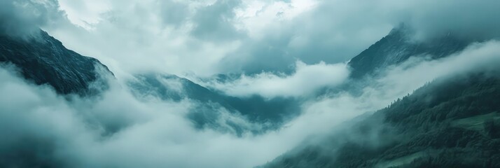 Fototapeta premium A mountain range covered in clouds