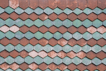 House facade blue and red decorative tiles texture close-up details.
