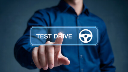 Man's finger presses glowing button with steering wheel icon, initiating a test drive experience.