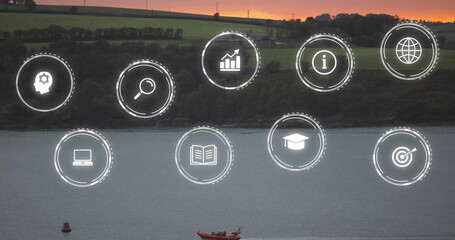 Floating ten white circular digital icons across waterfront at dusk, with red boat and buoy