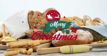 Featuring seeded loaf, baguettes on kitchen tabletop, with butter dish, Merry Christmas graphic