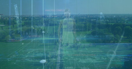 Standing woman wearing neon green sportswear at aerial park sports field markings, data panels