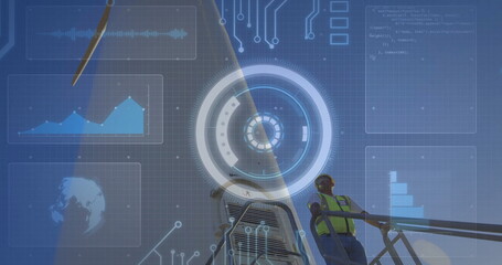 Inspecting technician wearing helmet and hi-vis vest using AR at wind energy platform, copy space