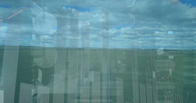 Hovering translucent financial data visual overlays above rural grassland, with charts and panels
