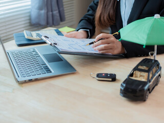 Car dealer or sales manager offers to sell a car and explains the conditions for signing a car contract and insurance contract. Close-up photo