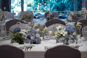 wedding reception dinner table suit set up with decoration flower before evening event start in the hall