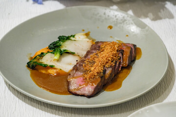 pack of sliced beef steak in dish with appetized vegetable