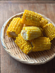Golden corn on the cob, rustic basket.