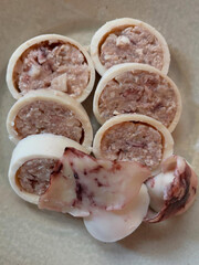 Sliced squid rolls with filling inside.