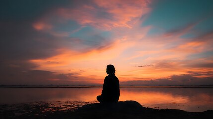 Silhouette of Person Watching Sunset Over Lake