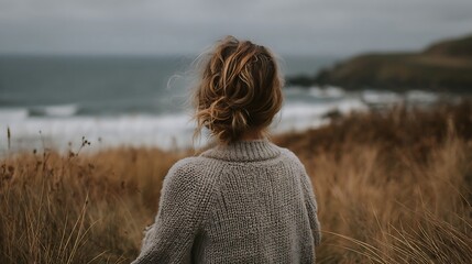Woman gazing at ocean, peaceful moment.