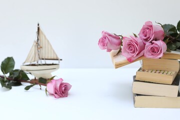 Romance, dream, bouquet of pink roses on the table, reading books, novel, free space
