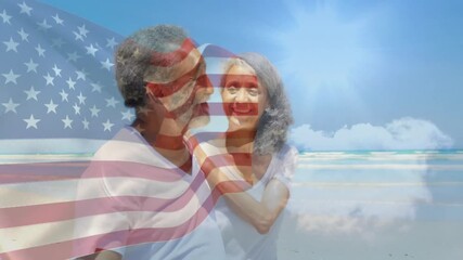 Senior couple sharing gestures celebrating patriotism on beach as transparent American flag fading - Powered by Adobe